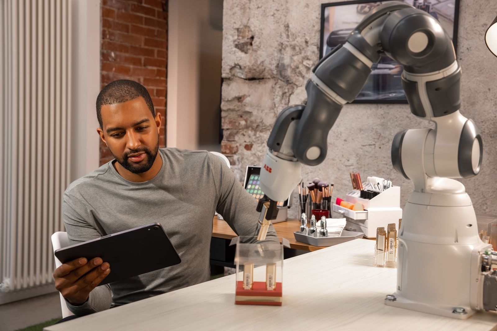 Engineer programming an industrial collaborative robotic arm
